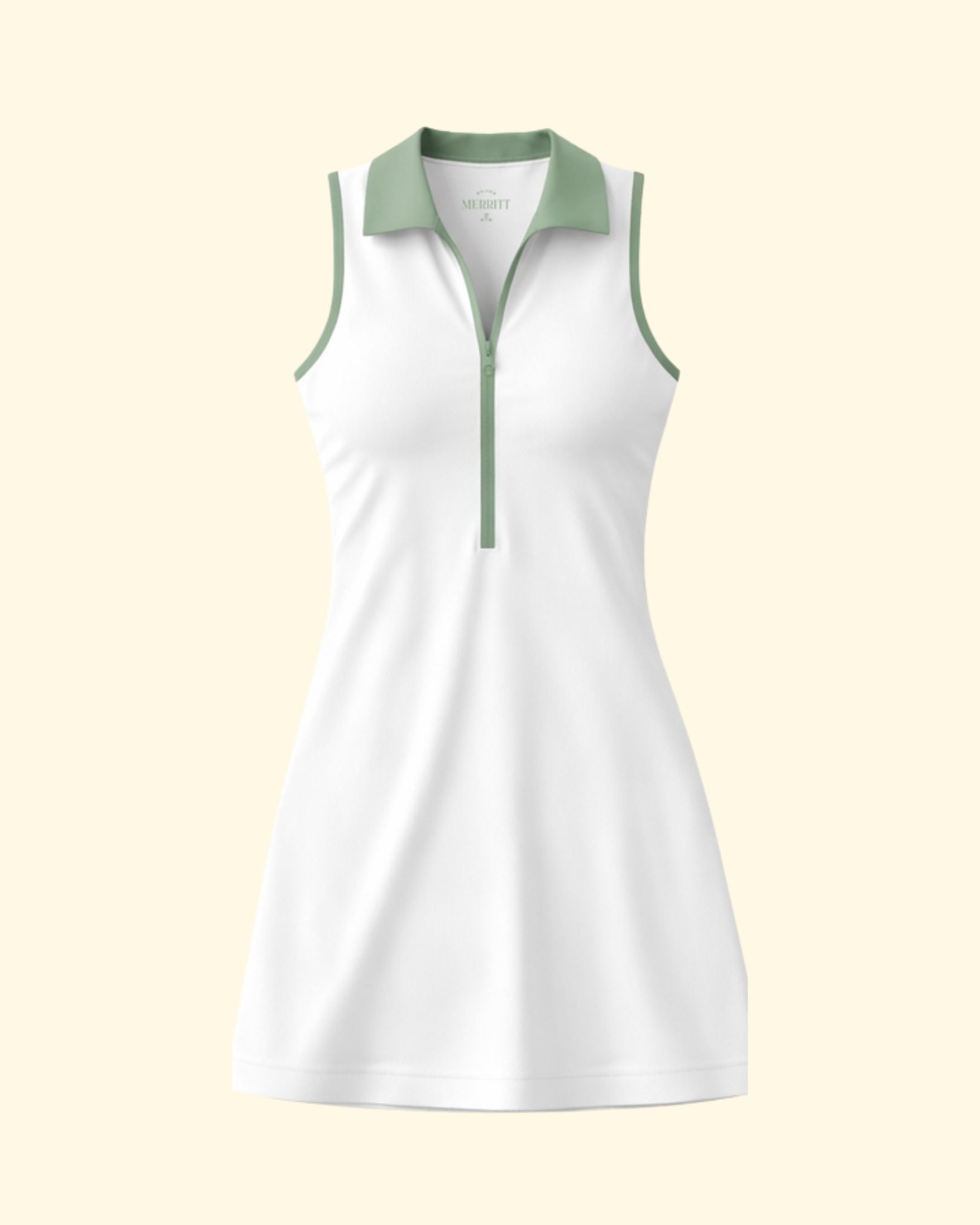 White sleeveless dress with green accents on a light beige background